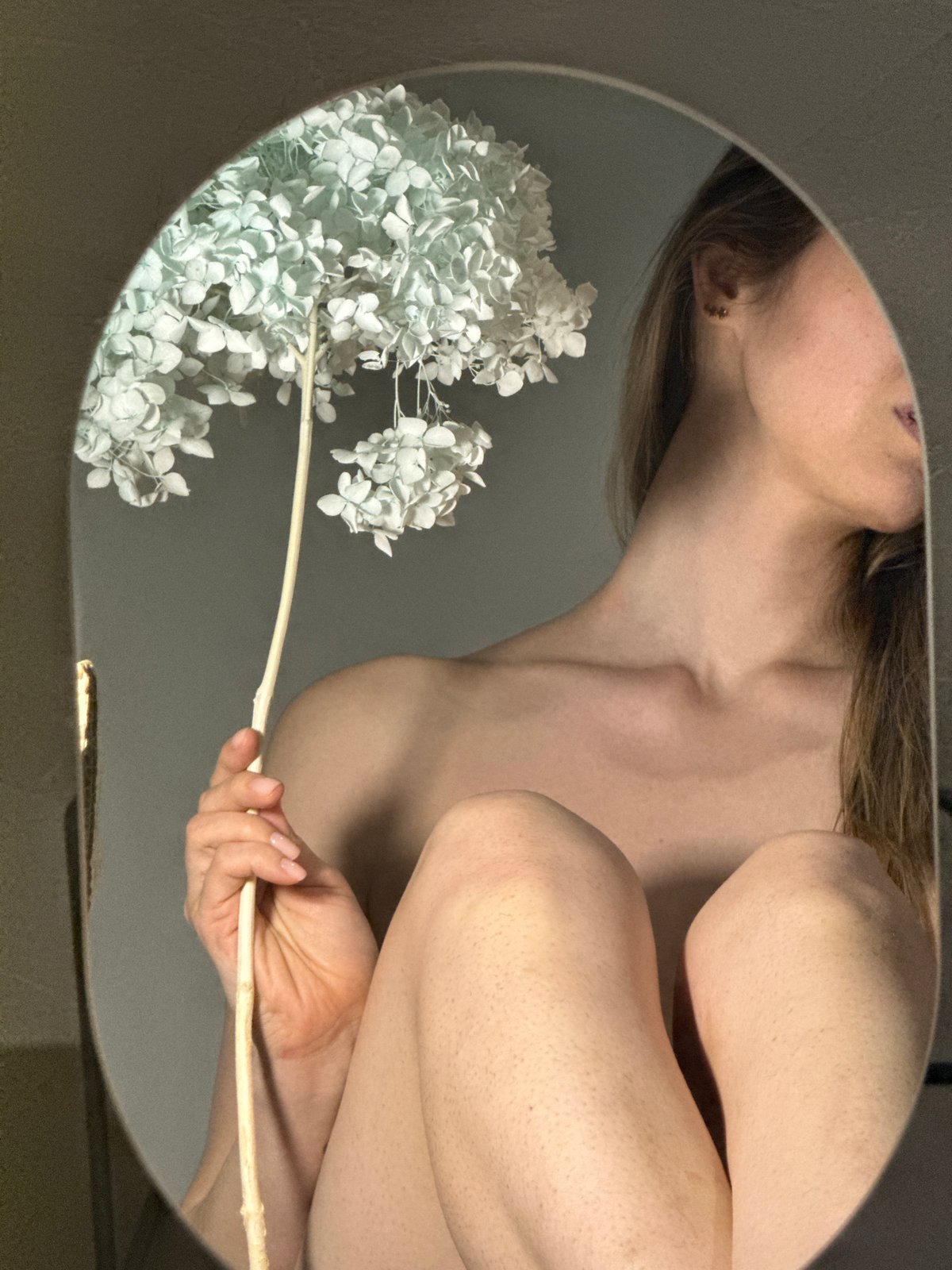 Woman takes floral mirror selfies in Chaikovsky, Russia