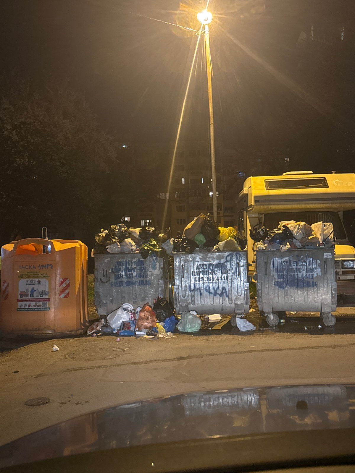 Overflowing waste containers observed on Sofia street at night