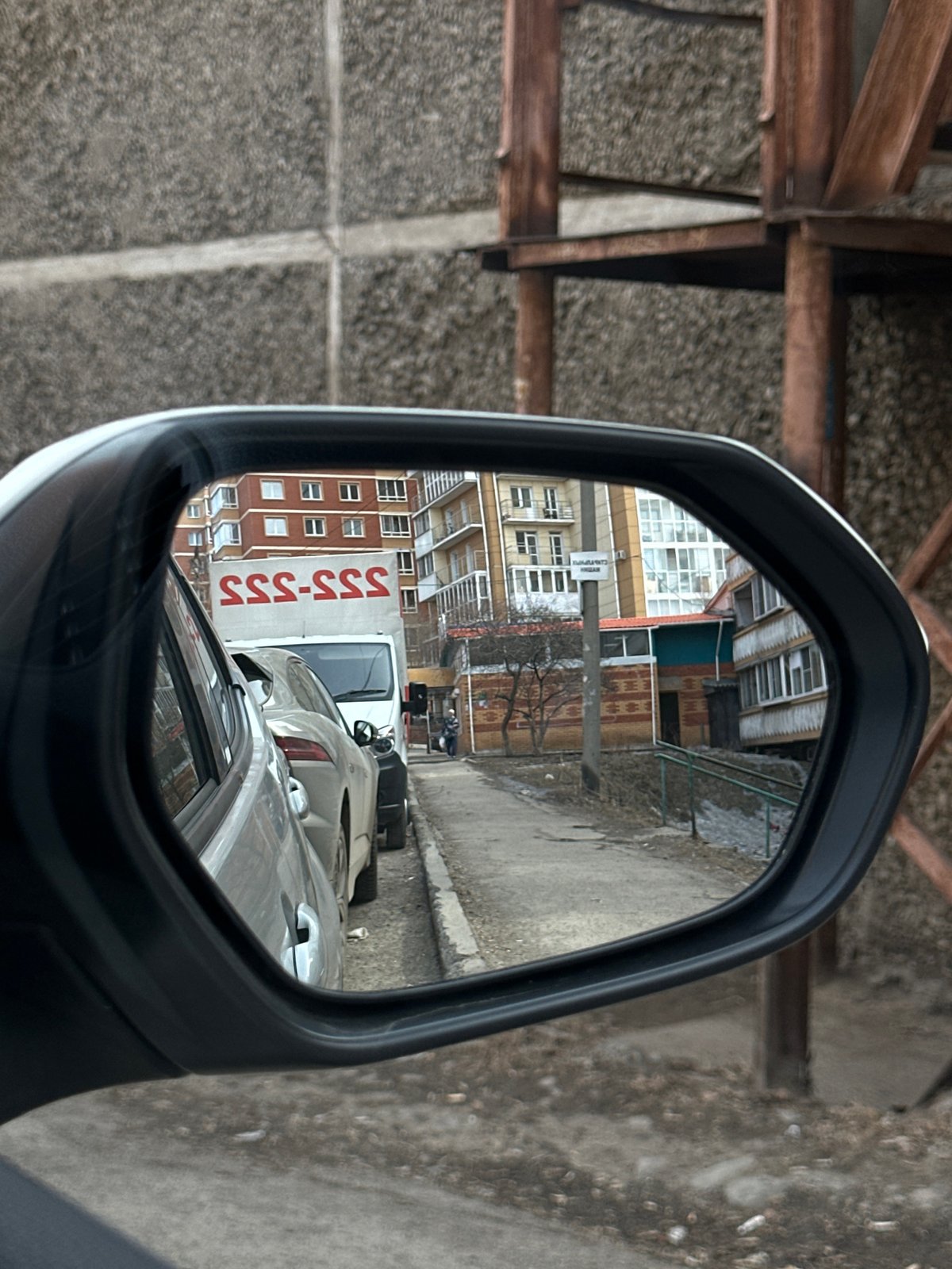 Morning street scene reflected in car mirror in Irkutsk