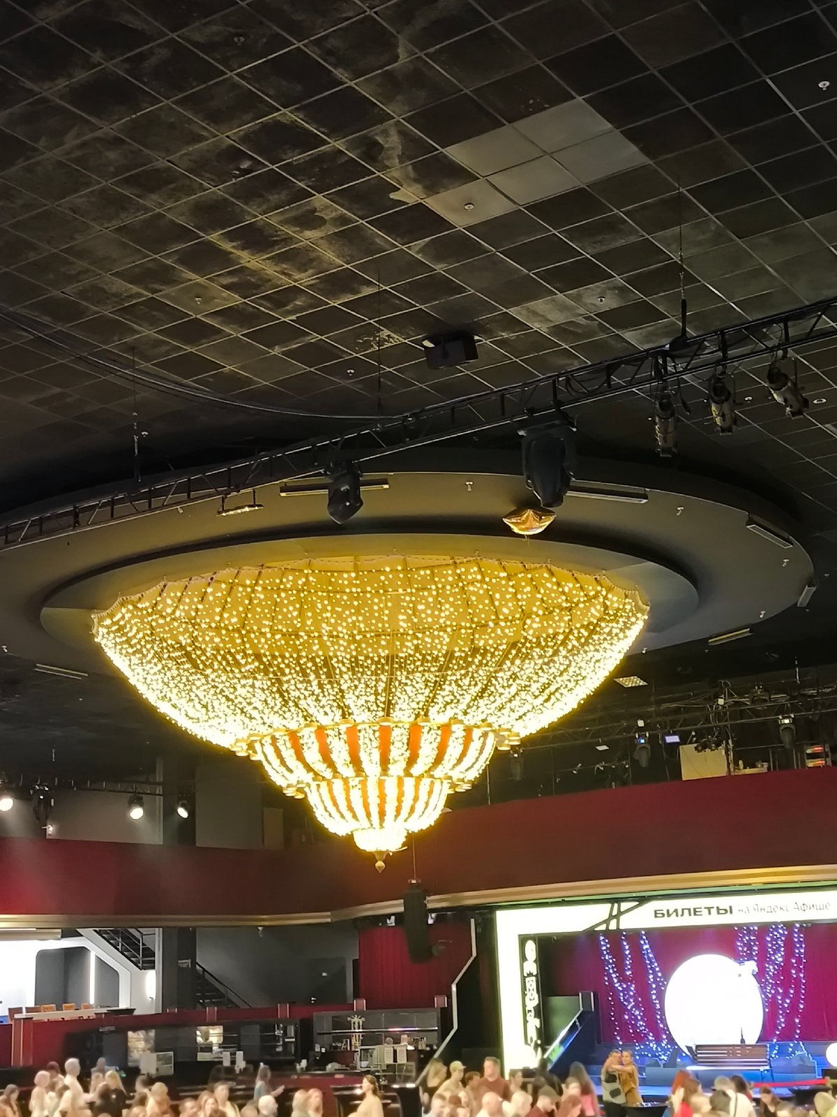 Theater performance with ornate staging draws audience phone flashlights