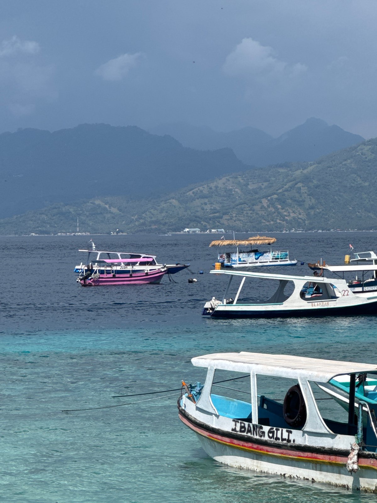 Gili Islands morning: boats, bikes, carriages, and beach life