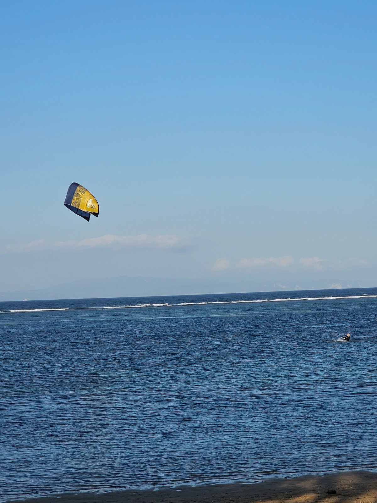 Kitesurfing off the Denpasar coast on a clear morning