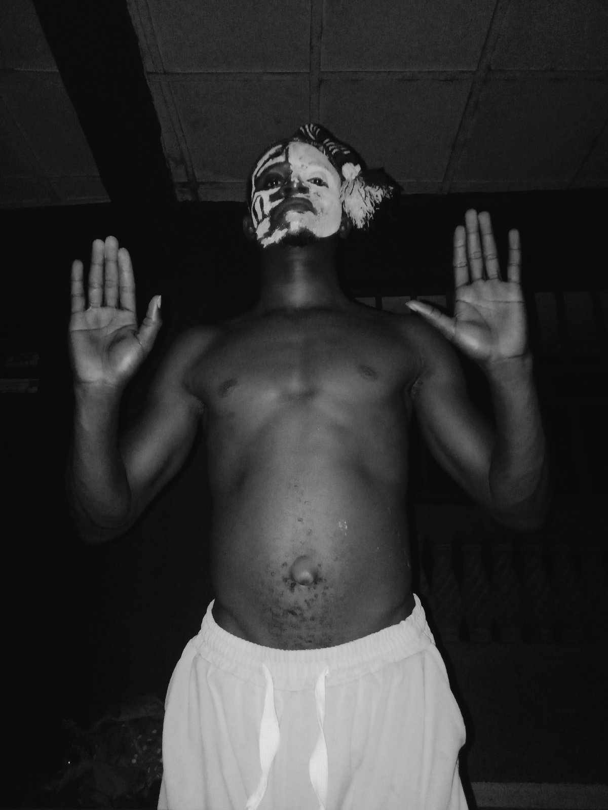 Individual photographed wearing striking black and white face paint