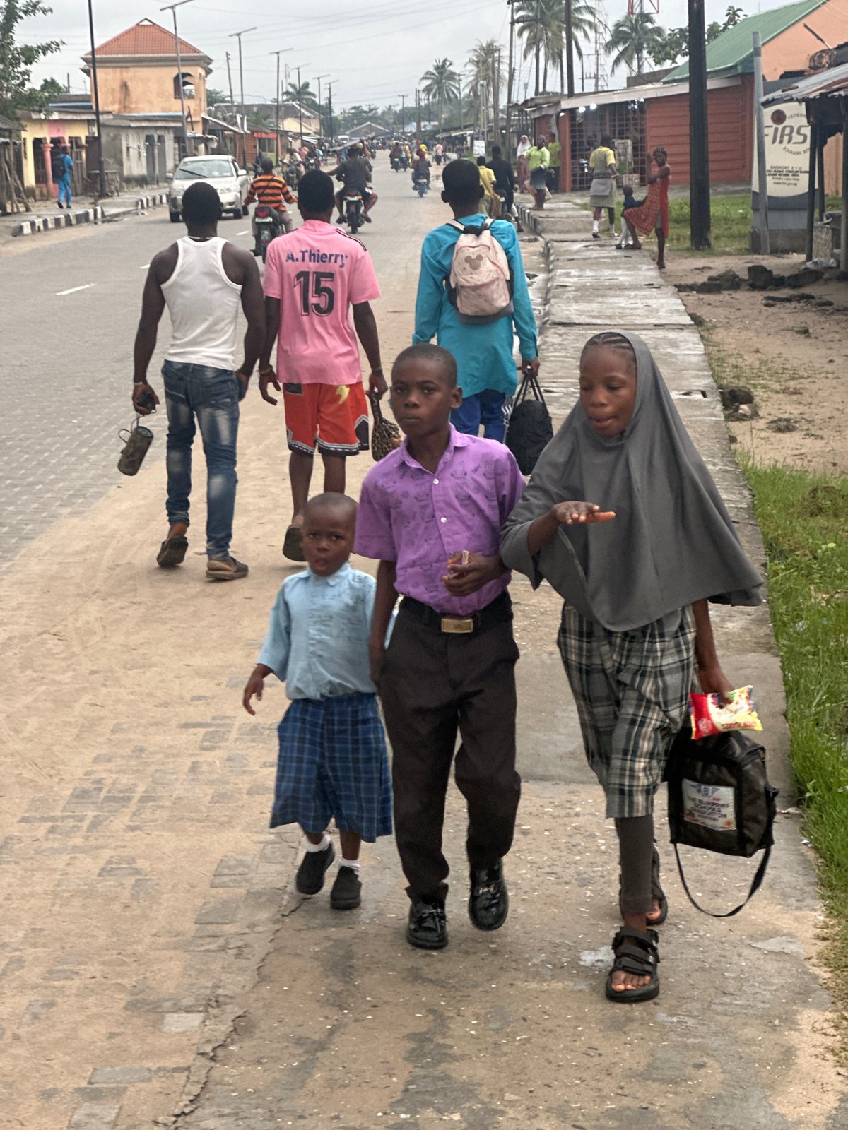 Morning foot traffic along a Badagry street
