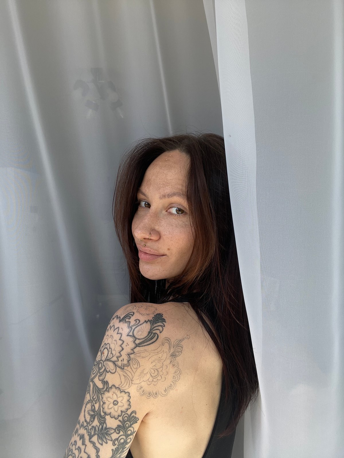 Woman with tattoos, piercings observed resting in Yakshur, Russia