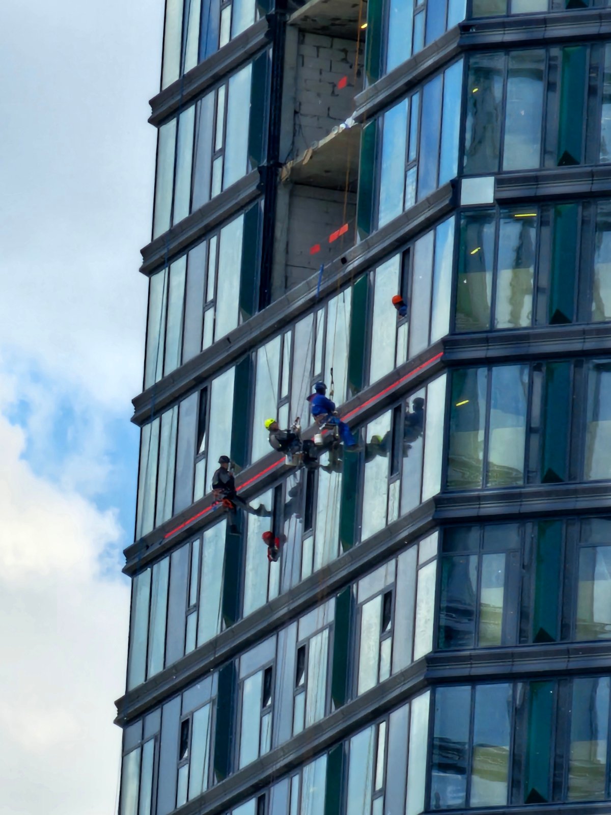 Window washers work on Moscow skyscraper exterior maintenance operations