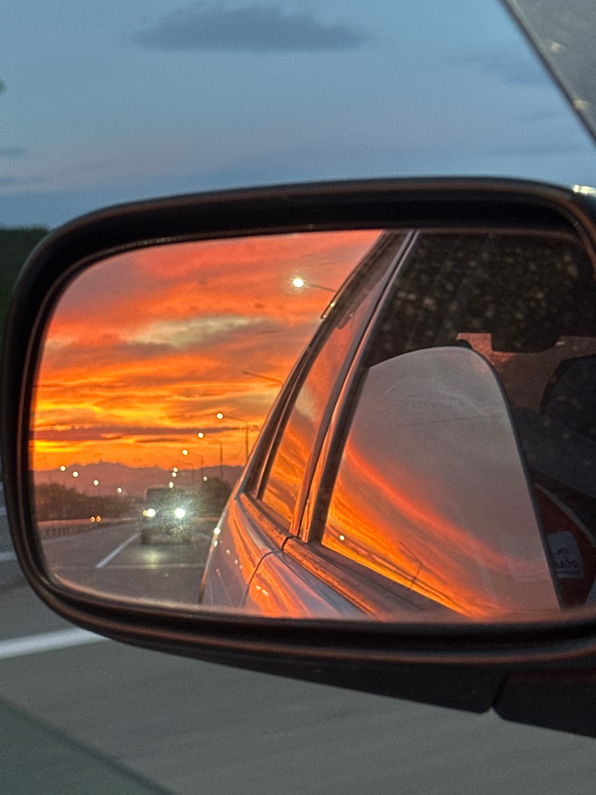 Yelizovo highway sunset caught in a car's side mirror