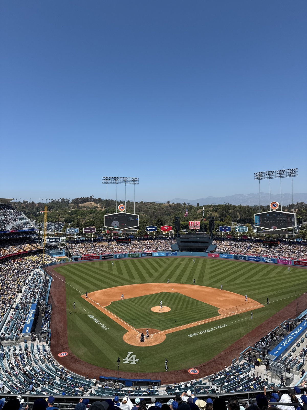 Baseball game underway at Dodger Stadium under sunny skies