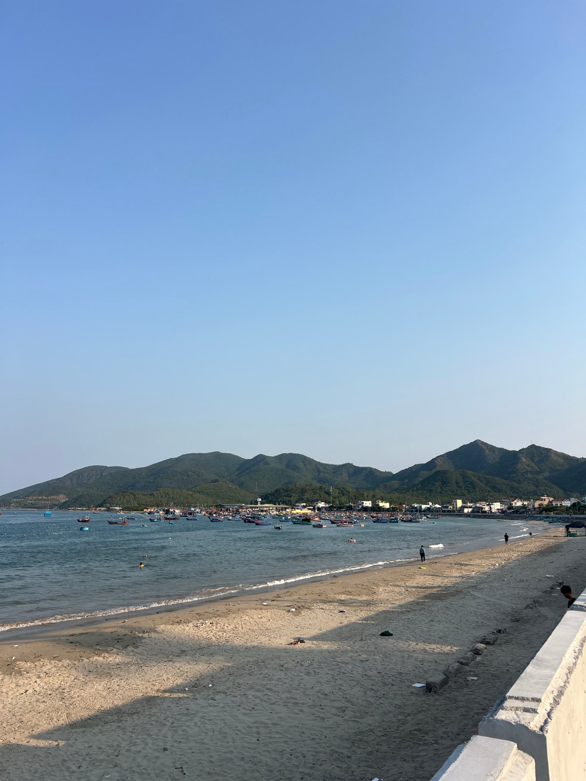 Tourist documents trash-littered beach scene in coastal Vietnam