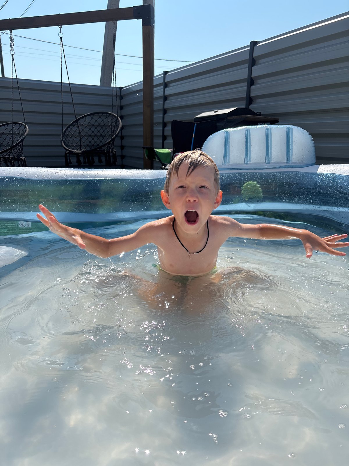 Backyard inflatable pool fun on a hot summer day in Chaikovsky