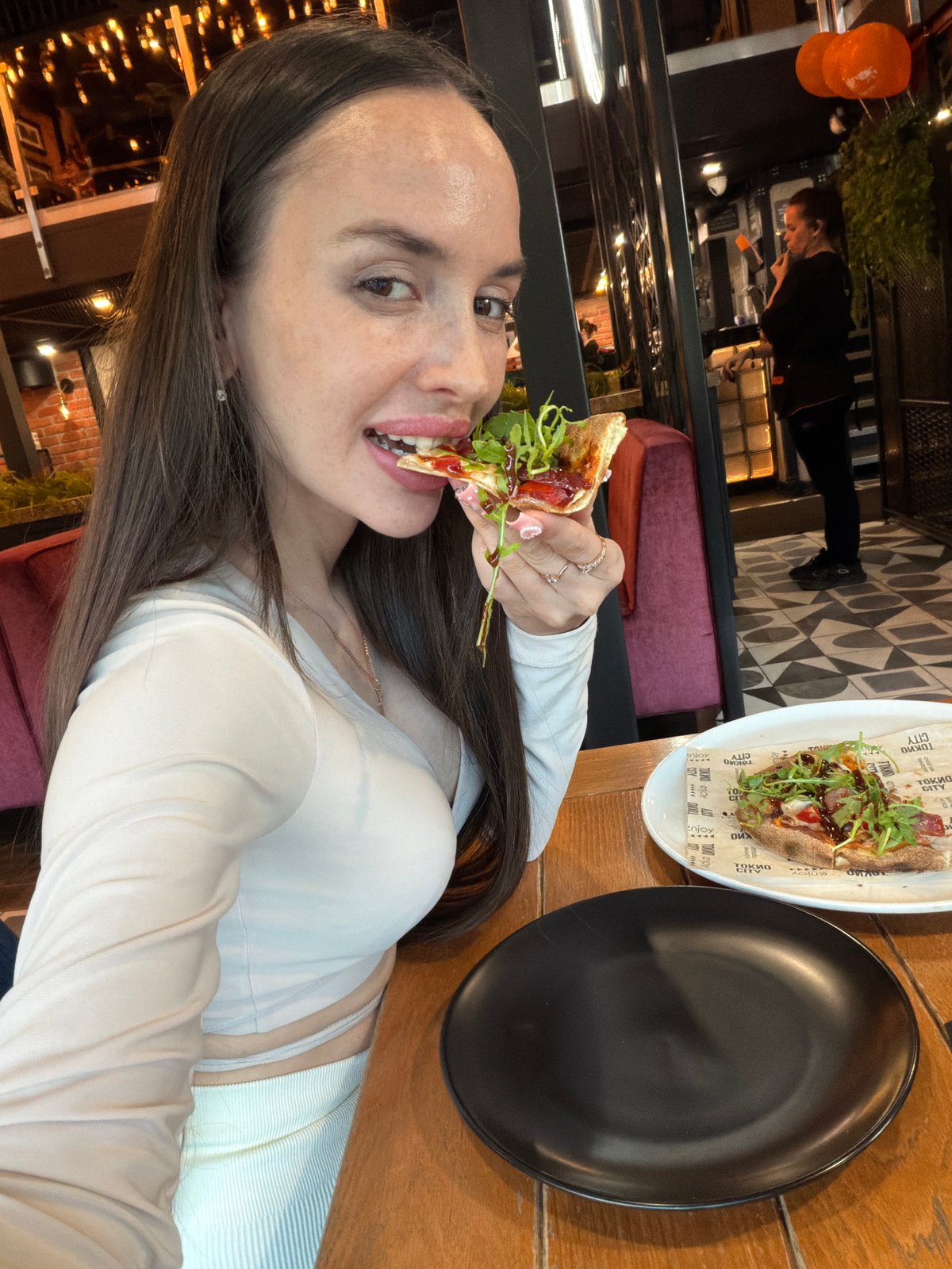 Woman documents sushi dinner with selfies at Saint Petersburg restaurant