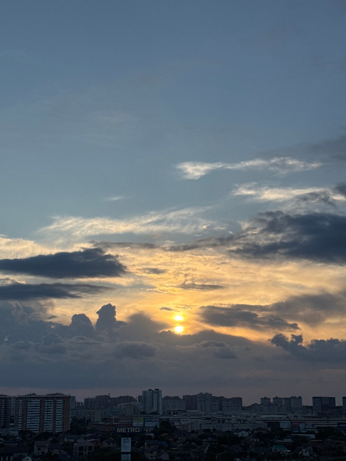 Krasnodar skyline at sunset, clouds and golden light