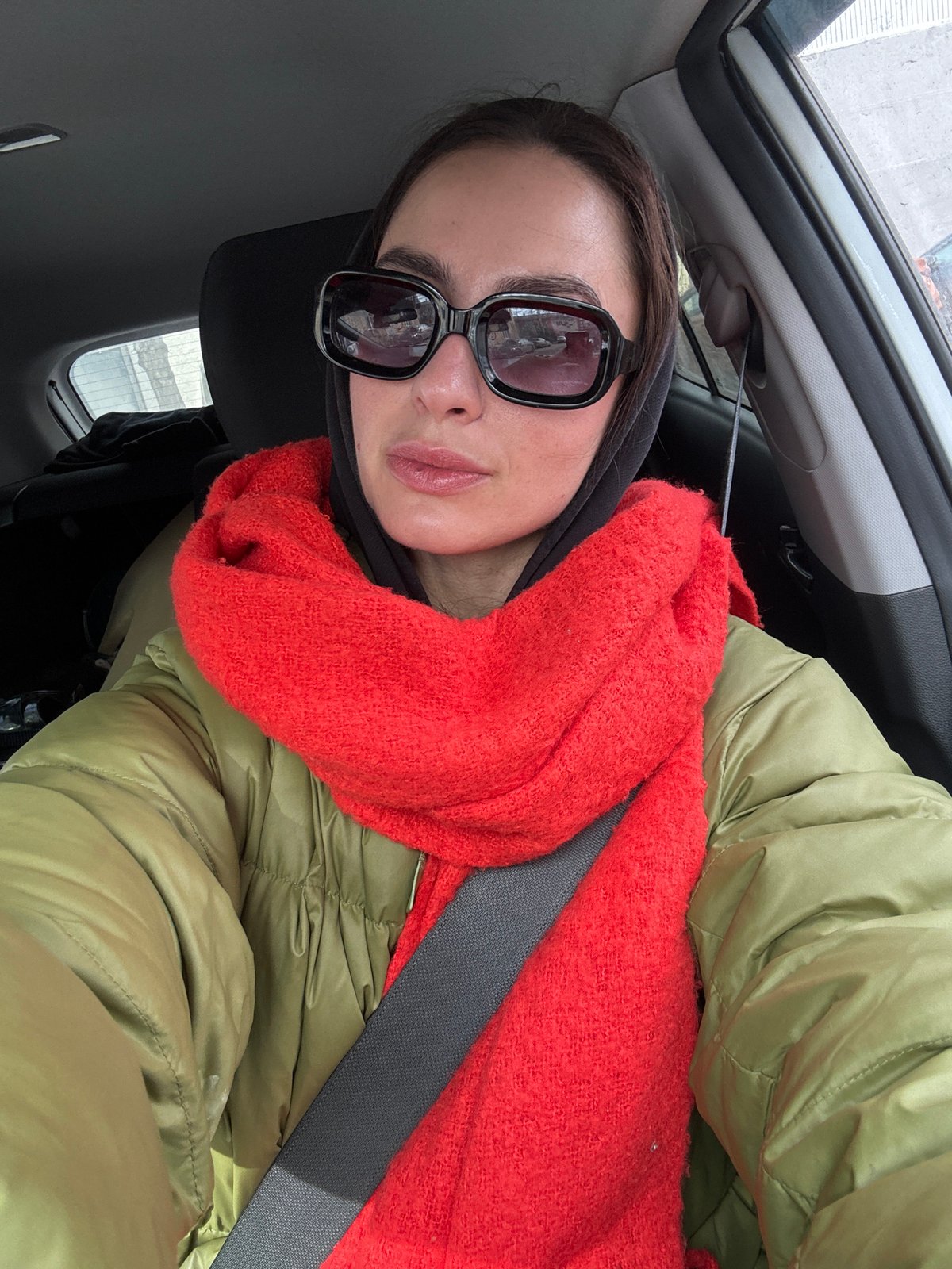 Woman in winter clothing observed in vehicle, Krasnoyarsk
