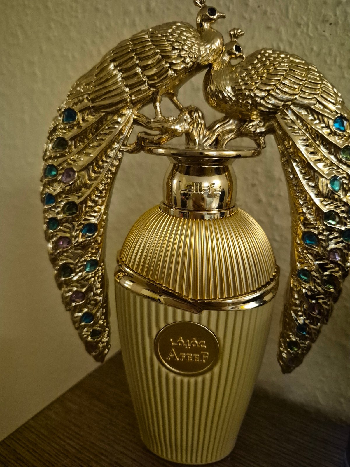 Ornate peacock perfume bottle and assorted decorative items