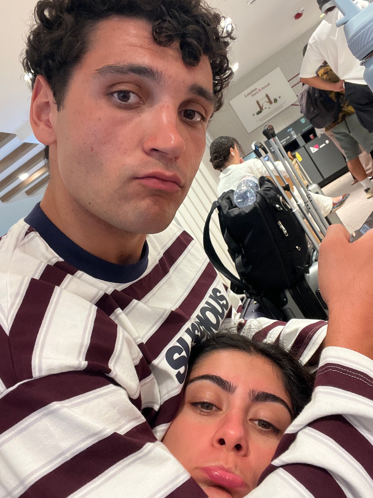 Couple selfies in Mykonos, matching outfits, indoor setting