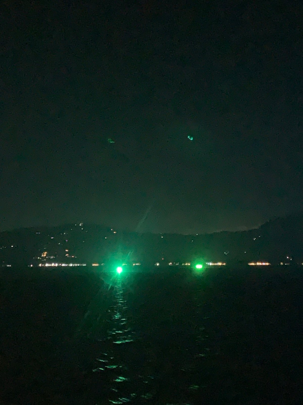 Nighttime lights reflect in water at Ko Samui, Thailand