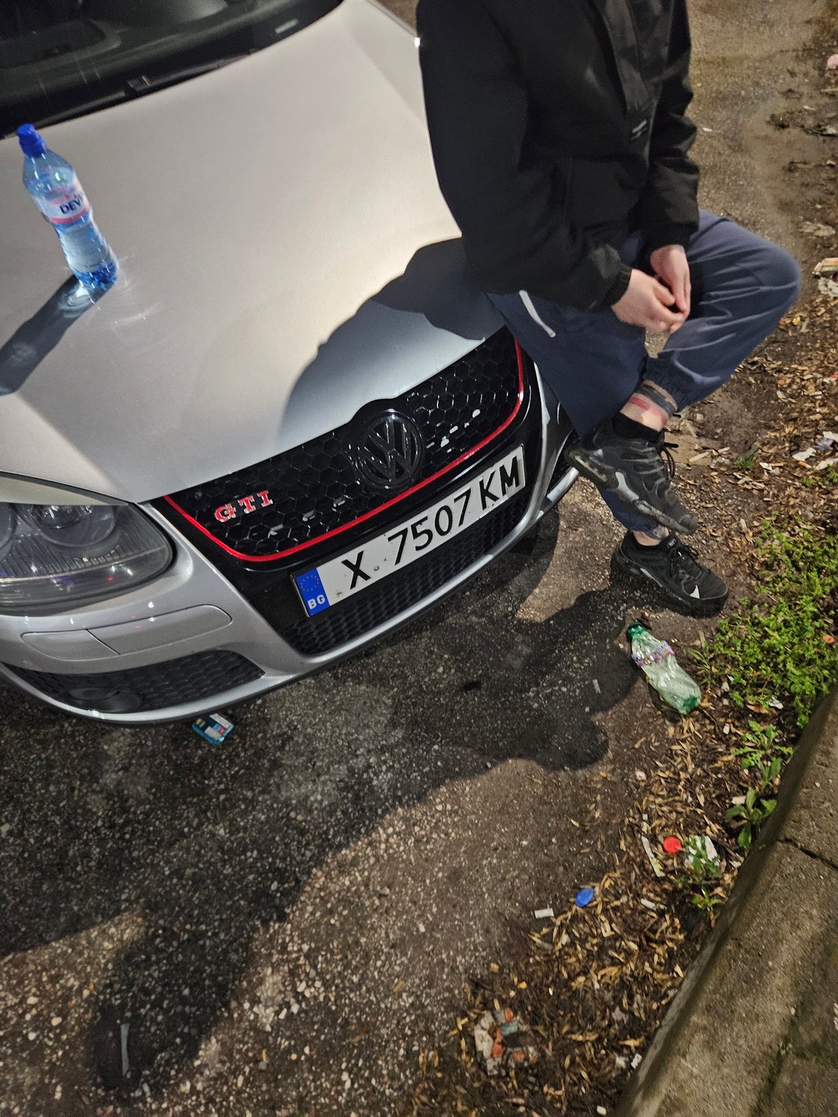 Person sits on car hood in Dimitrovgrad Bulgaria