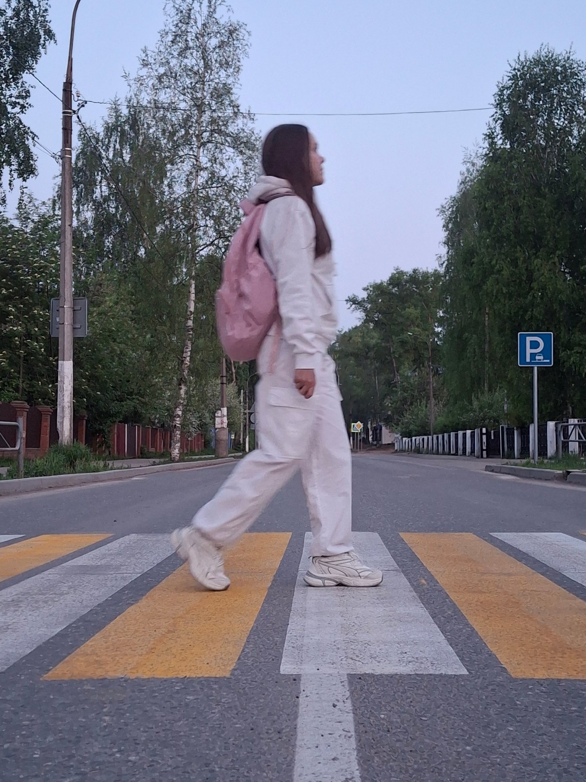 Evening pedestrian crossing and lilac blooms captured in Chaikovsky