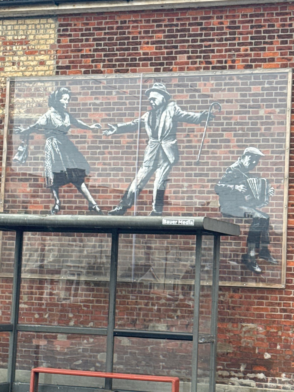 Street mural shows dancing figures, accordion player in Great Yarmouth