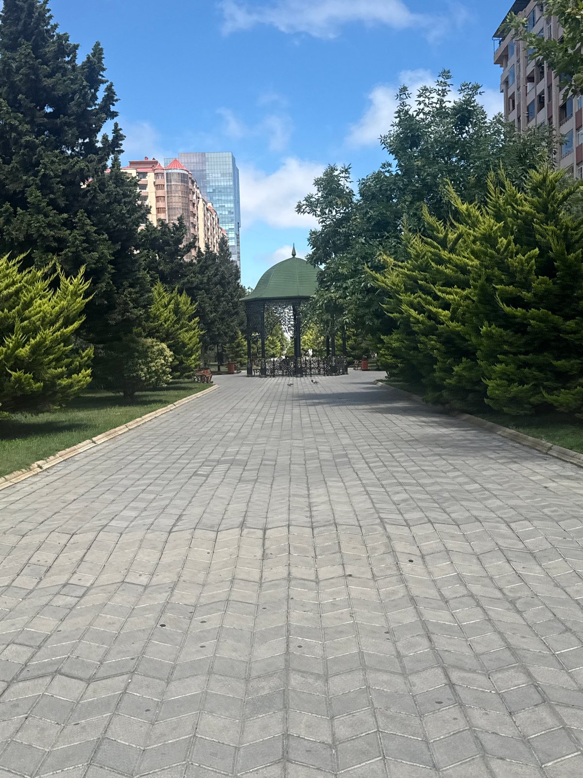 Chevron-paved park path leads to a gazebo in Khatay Raion