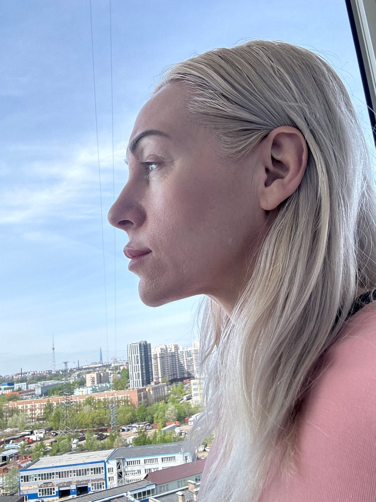 Woman documents Russian cityscape from elevated viewpoint