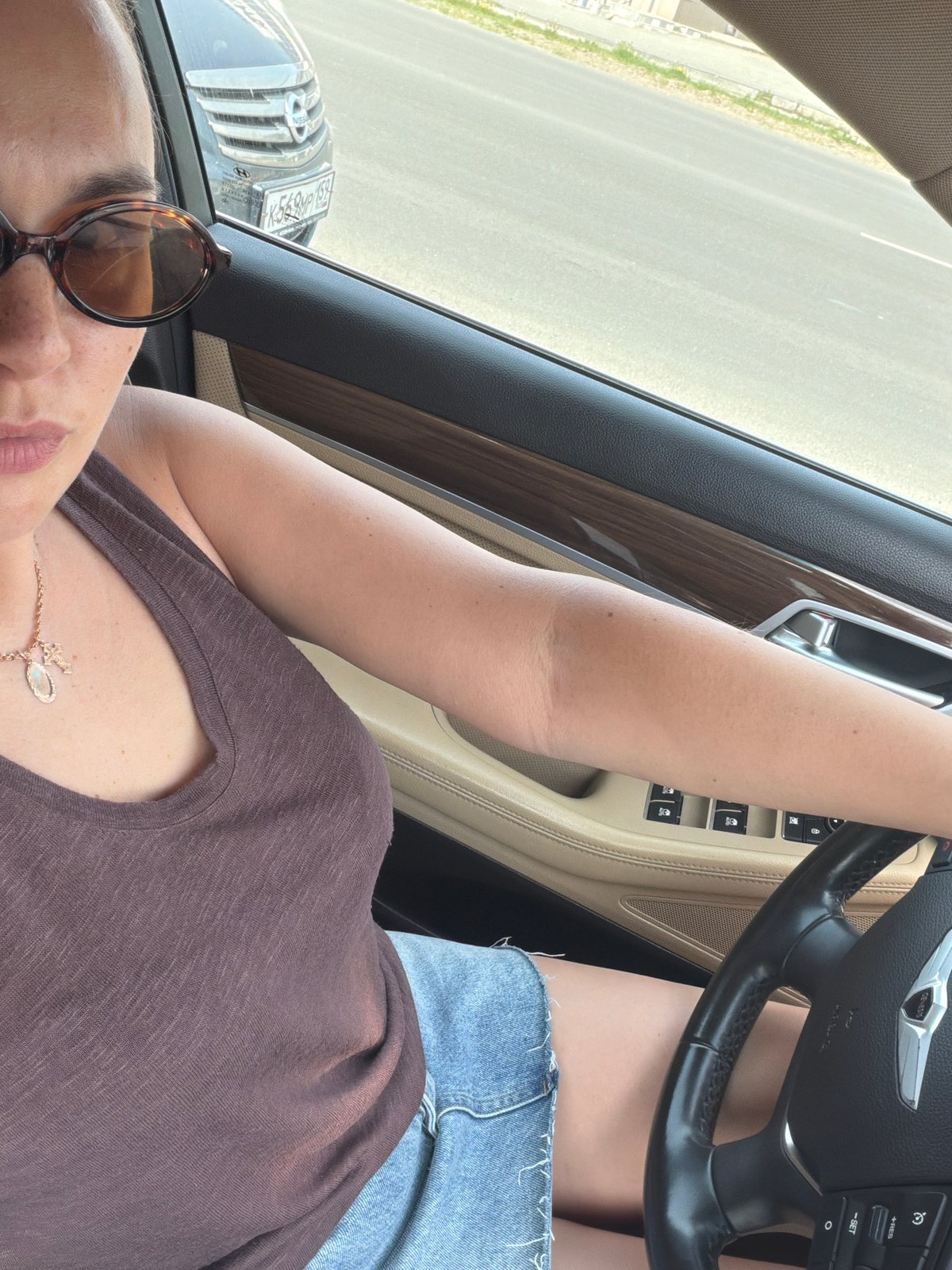 Woman photographed in Genesis car amid street scenes in Chaikovsky
