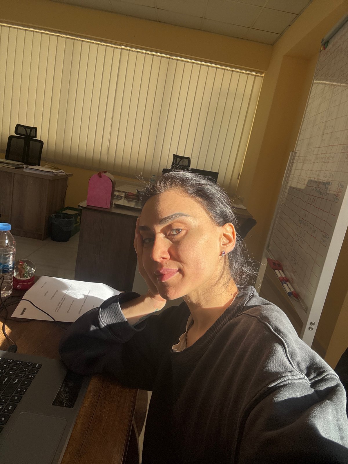 Woman working late night at desk in Tbilisi