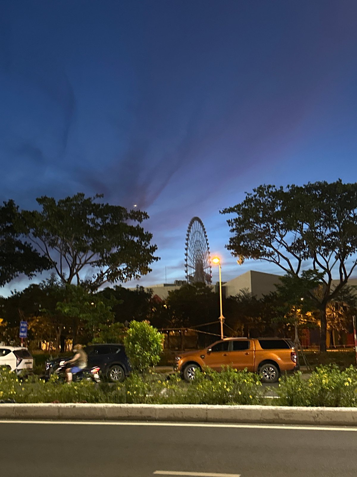 Da Nang city streets at twilight, Ferris wheel on the horizon