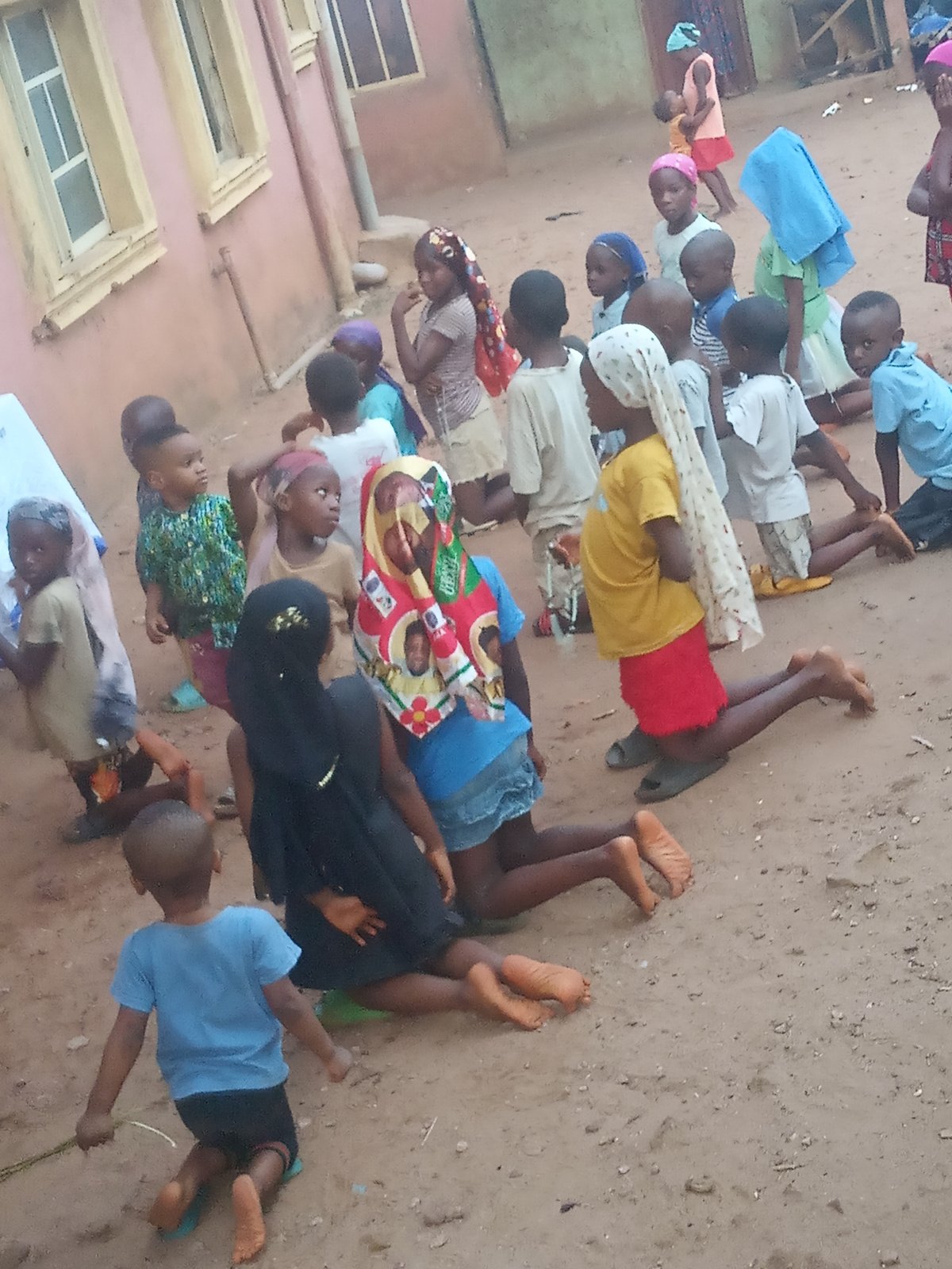 Children play football on dirt fields in Nigerian villages