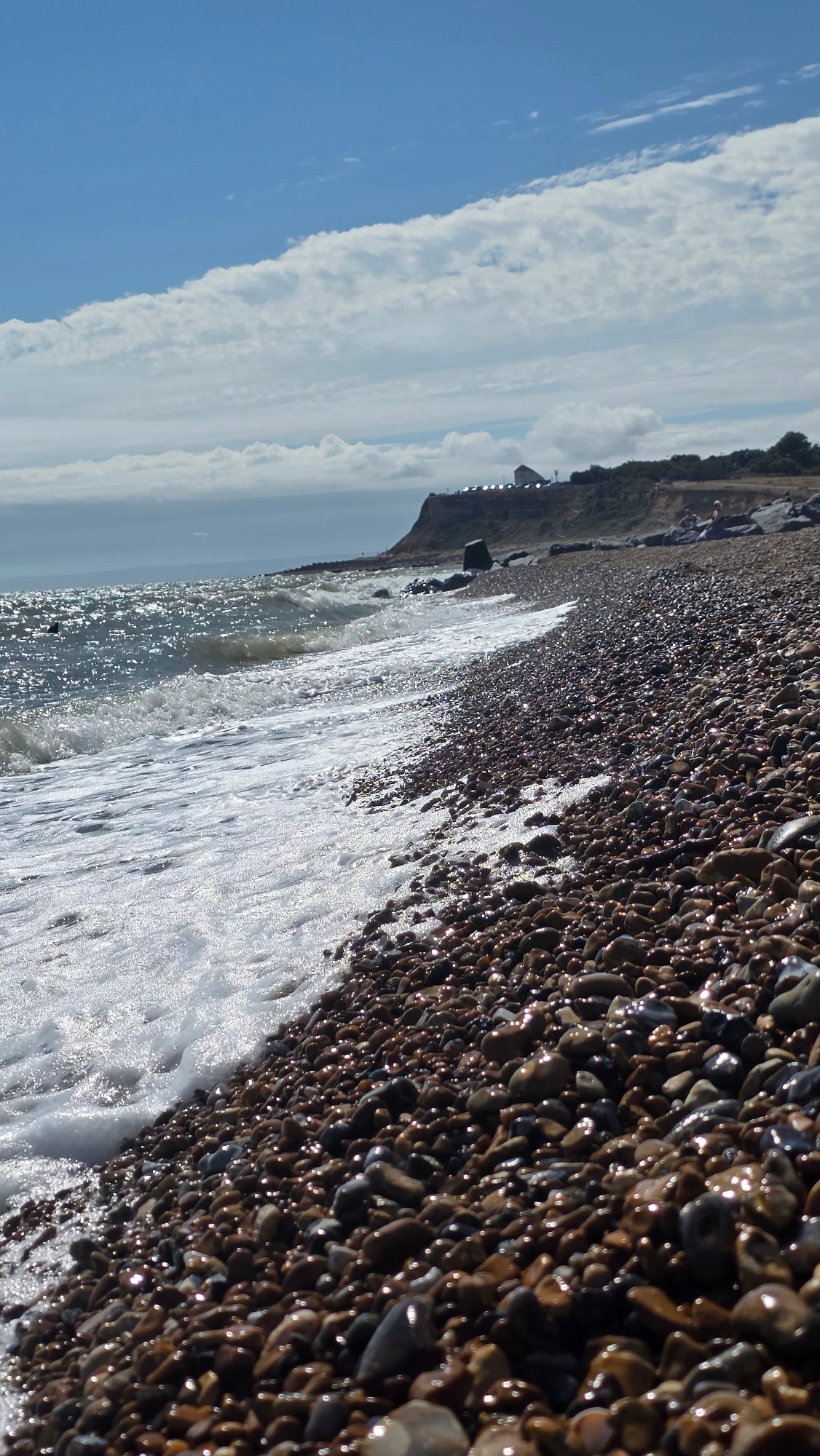 Paddington Bear and waves on a St Leonards pebble beach