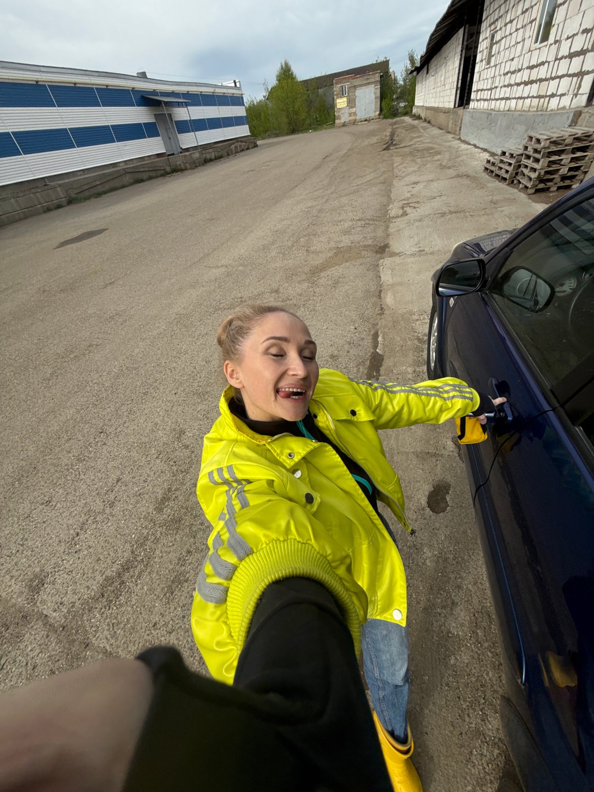 Woman observed entering, sitting in blue car in Chaikovsky