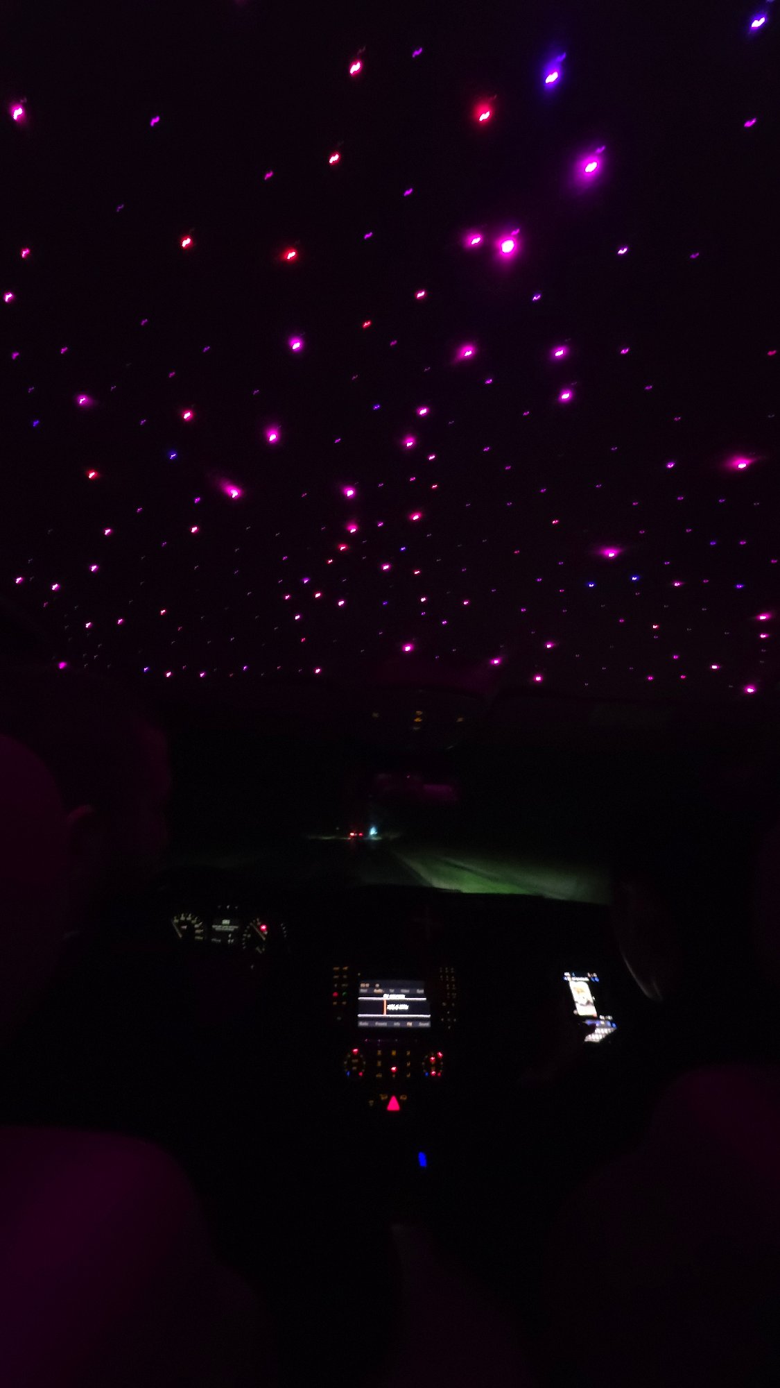 Dark vehicle interior with glowing decorations observed in Oreshak