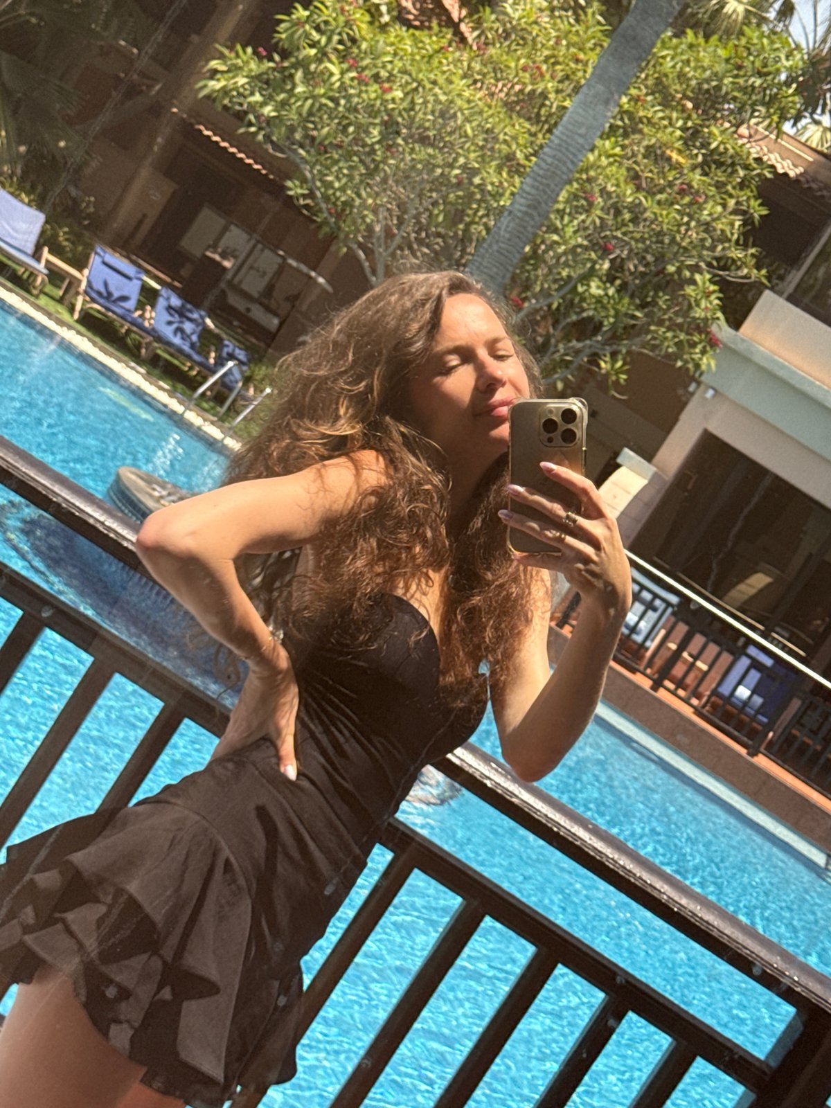 Woman takes poolside selfies at Dubai resort Monday morning