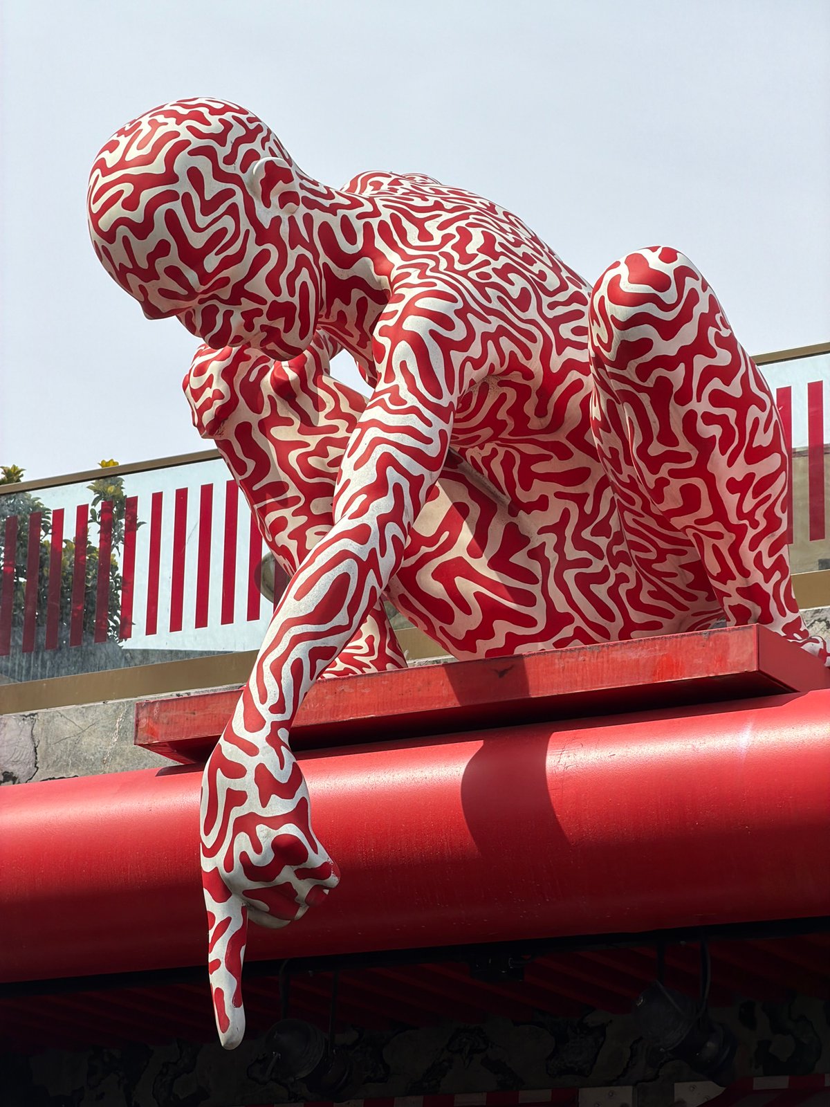 Maze-patterned human sculpture spotted near red column in Istanbul