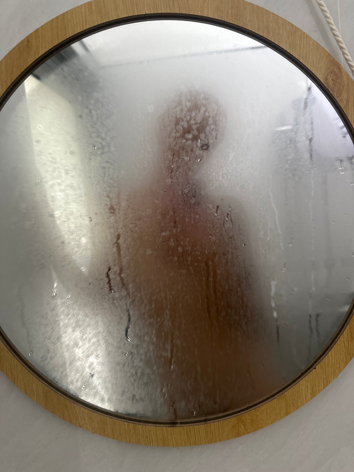 Person captured in fogged bathroom mirror in Vietnam