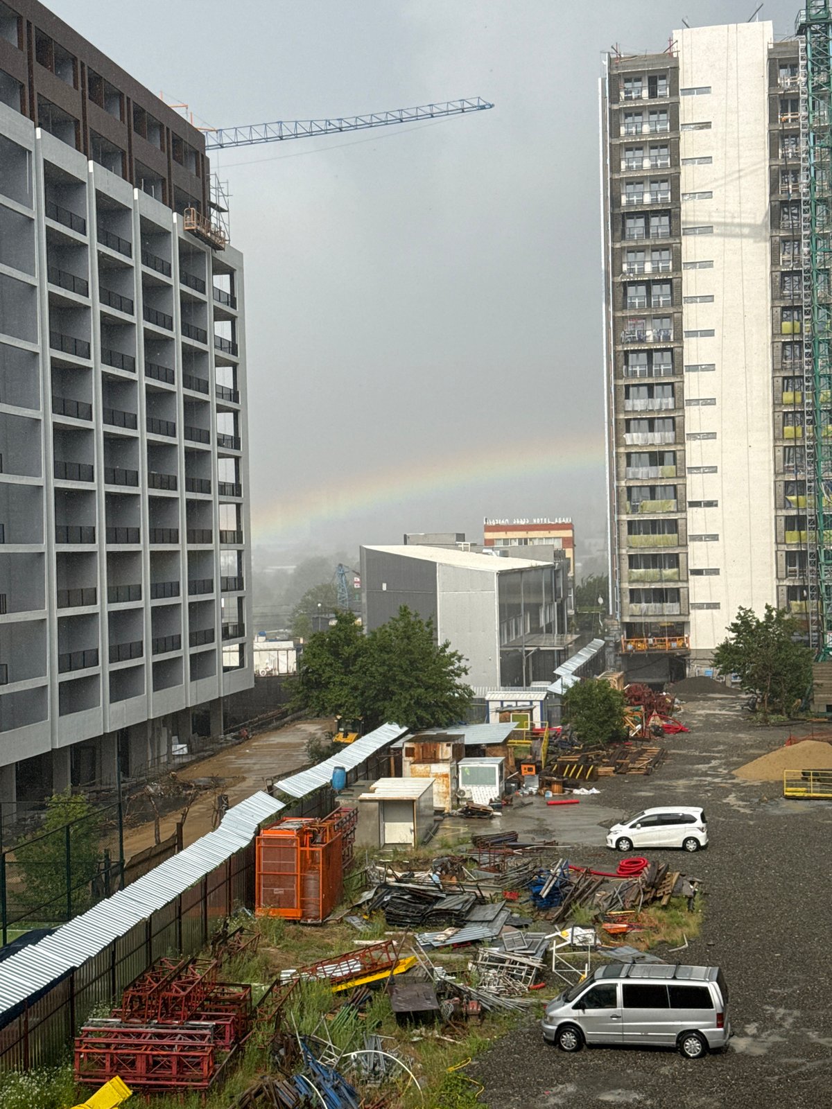 Rainy afternoon at a Tbilisi construction site, rainbow included