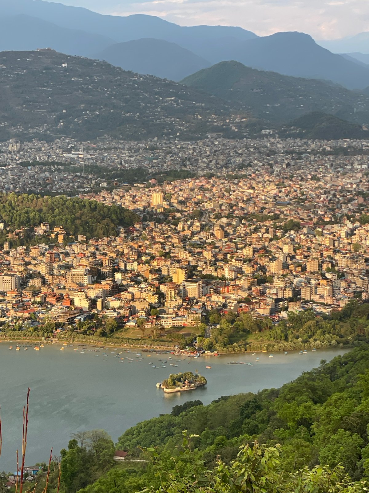 Dense urban development observed in Pokhara between mountains, lake