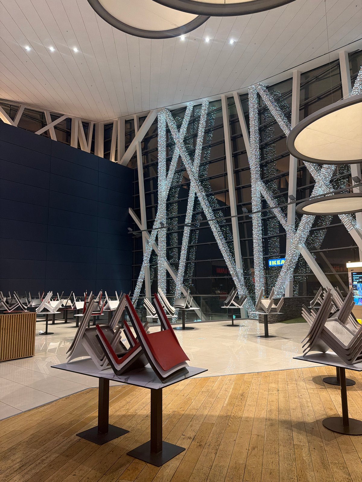 Person moves through Sofia mall taking selfies in evening