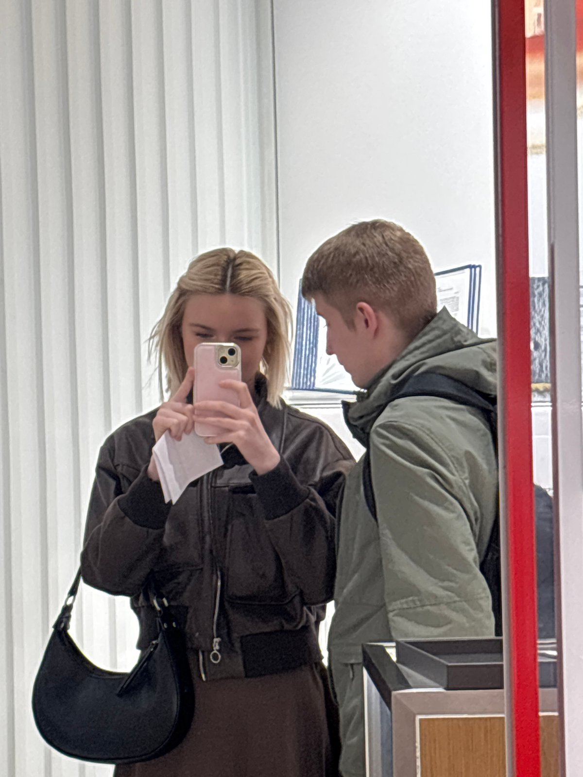 Woman photographs document using smartphone mirror reflection in Russia