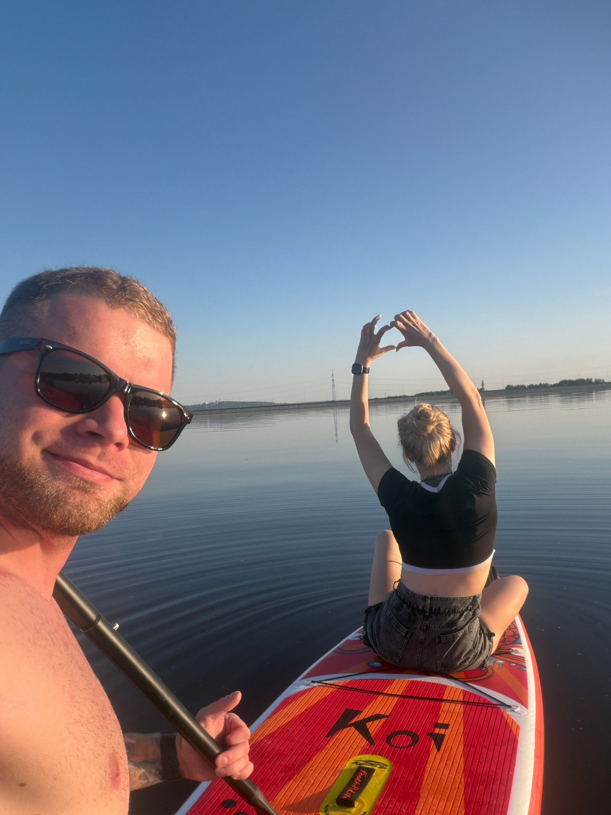 Couple enjoys afternoon paddleboarding session near Chaikovsky, Russia