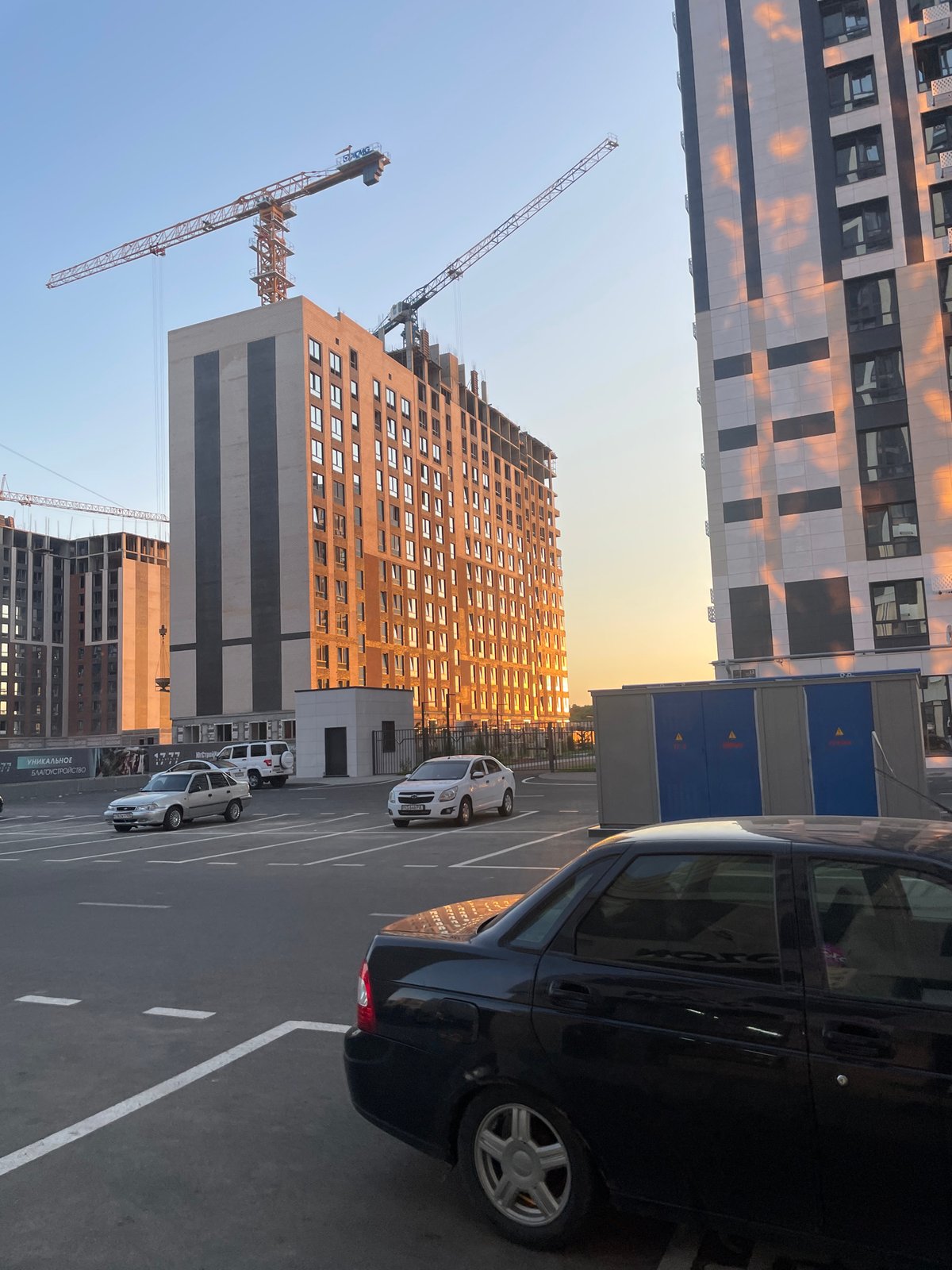 Stavropol high-rise development at sunset, street life nearby