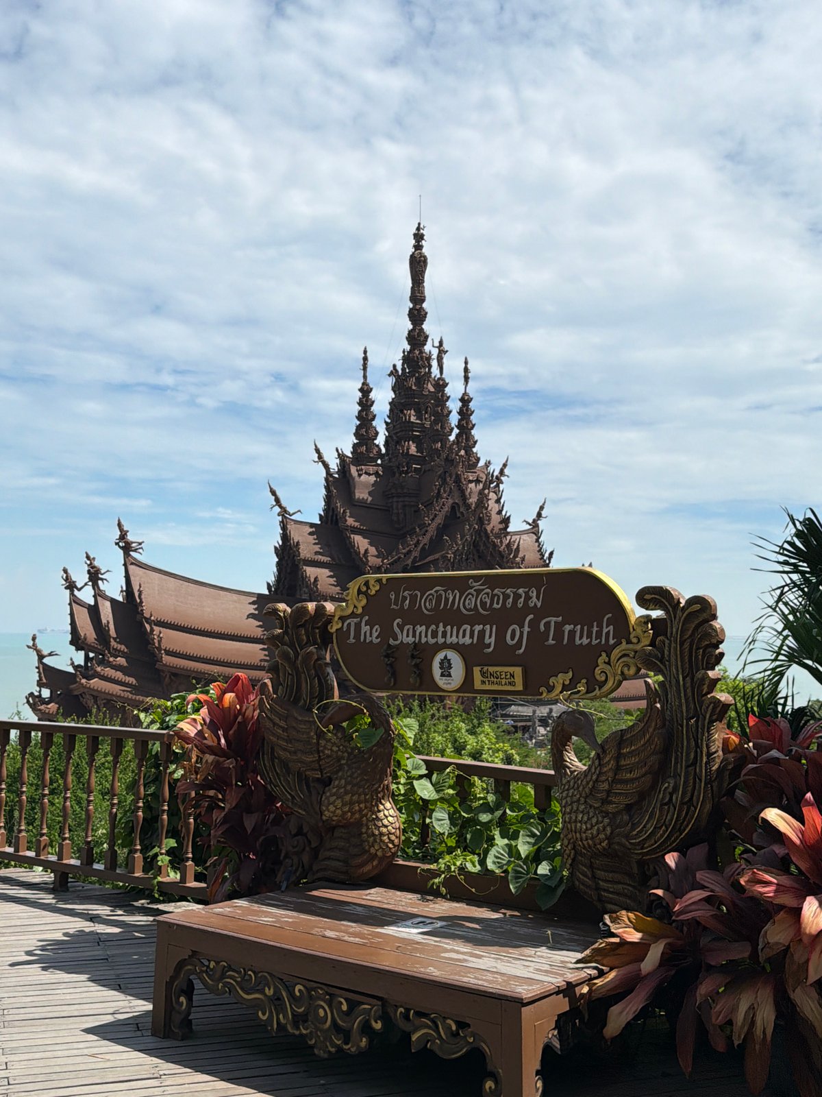 Tourist visits ornate wooden Sanctuary of Truth temple in Pattaya
