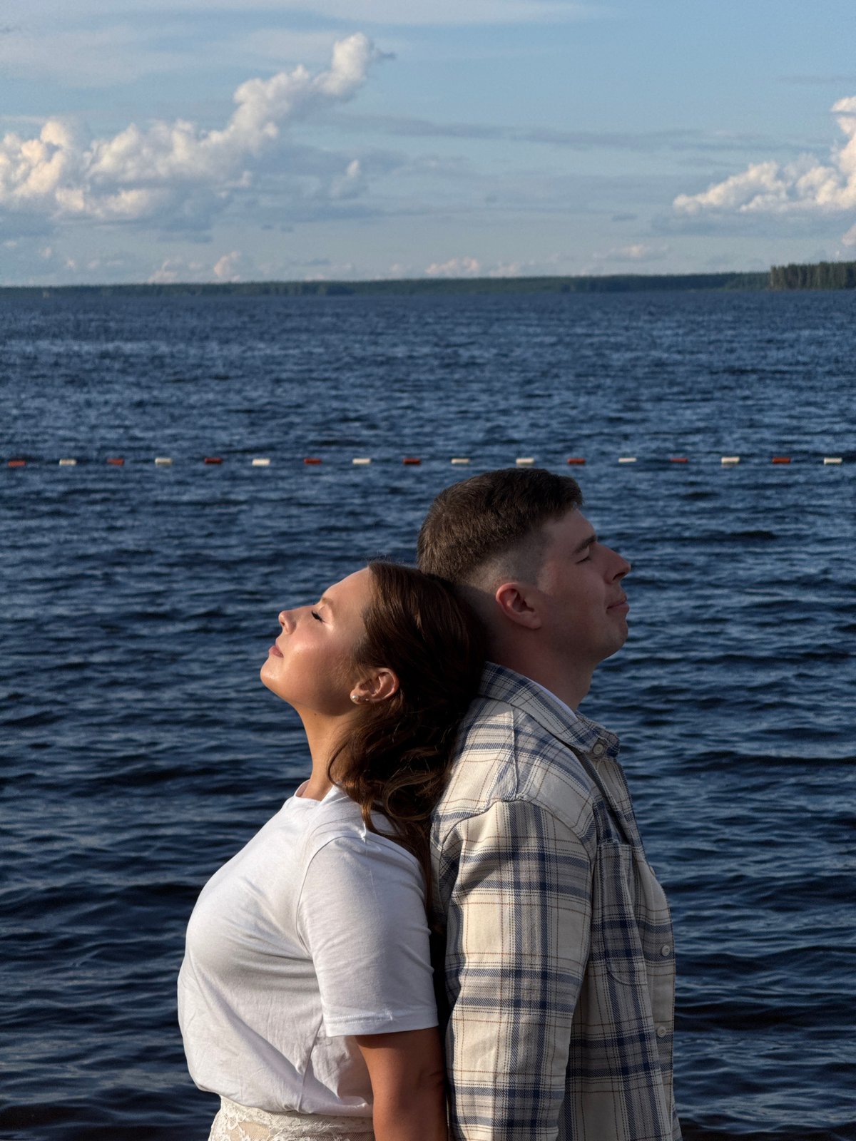 Couple enjoys romantic afternoon by lake in Chaikovsky, Russia