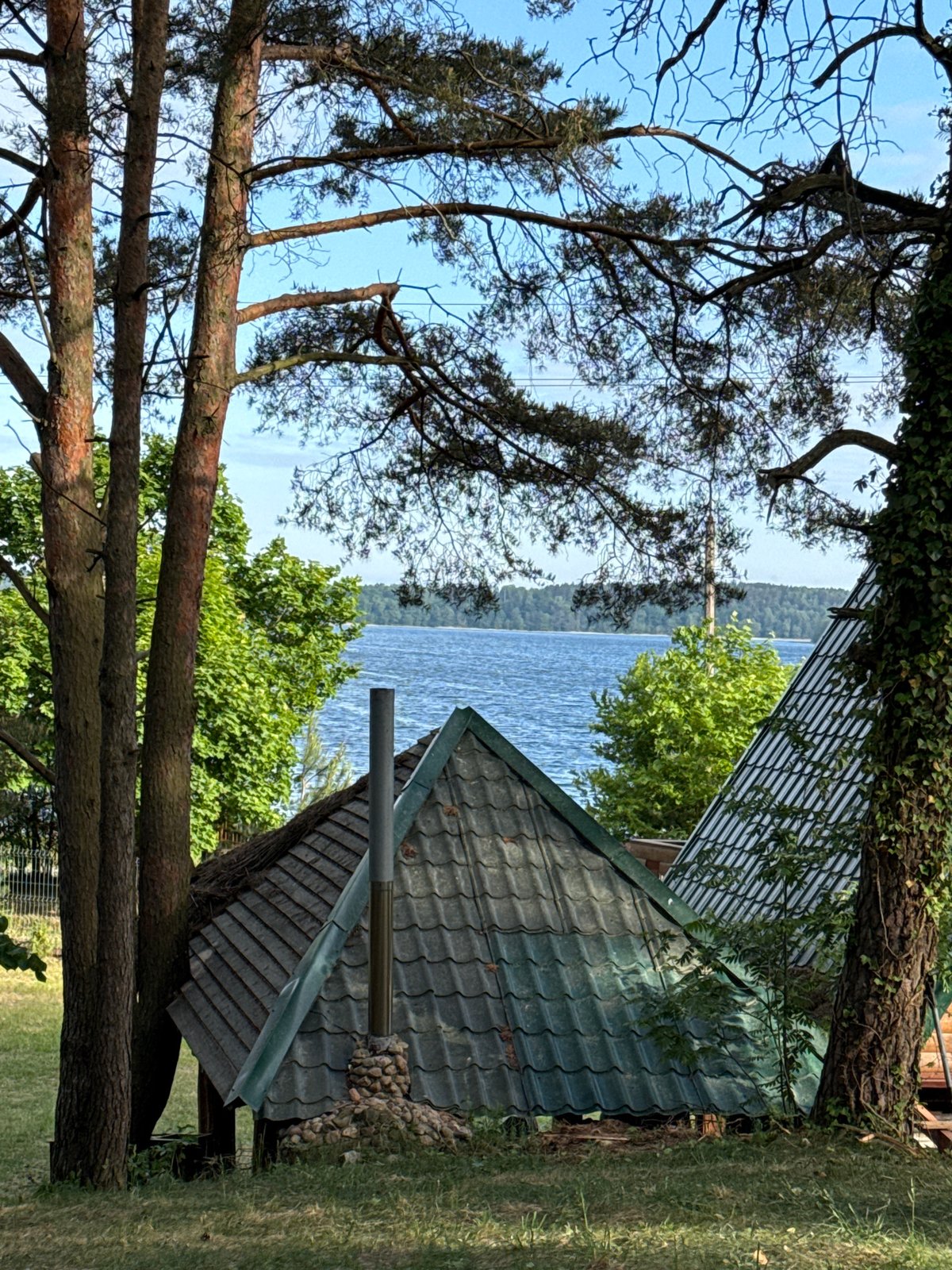 Morning lakeside documentation at Polish forest retreat captures peaceful moments
