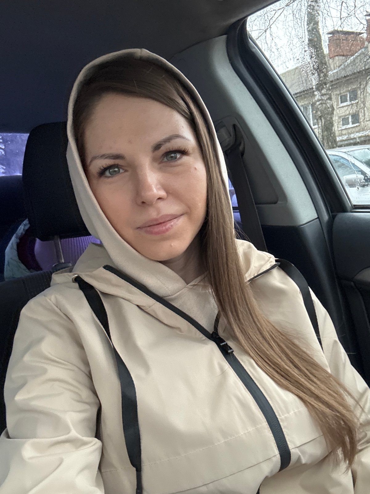 Woman photographed in car in Раздолье, Russia early morning