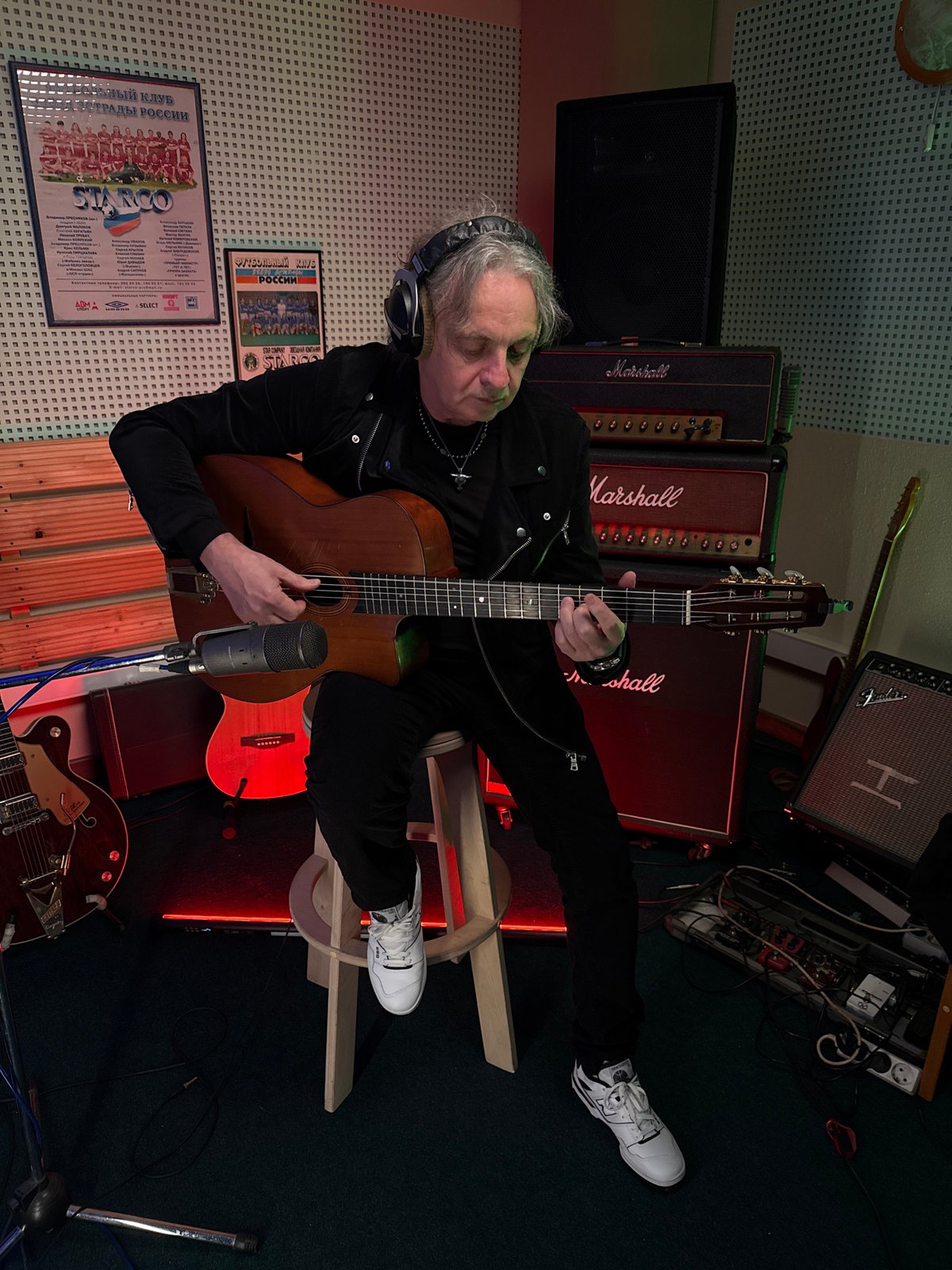Musician records acoustic guitar session in Moscow studio