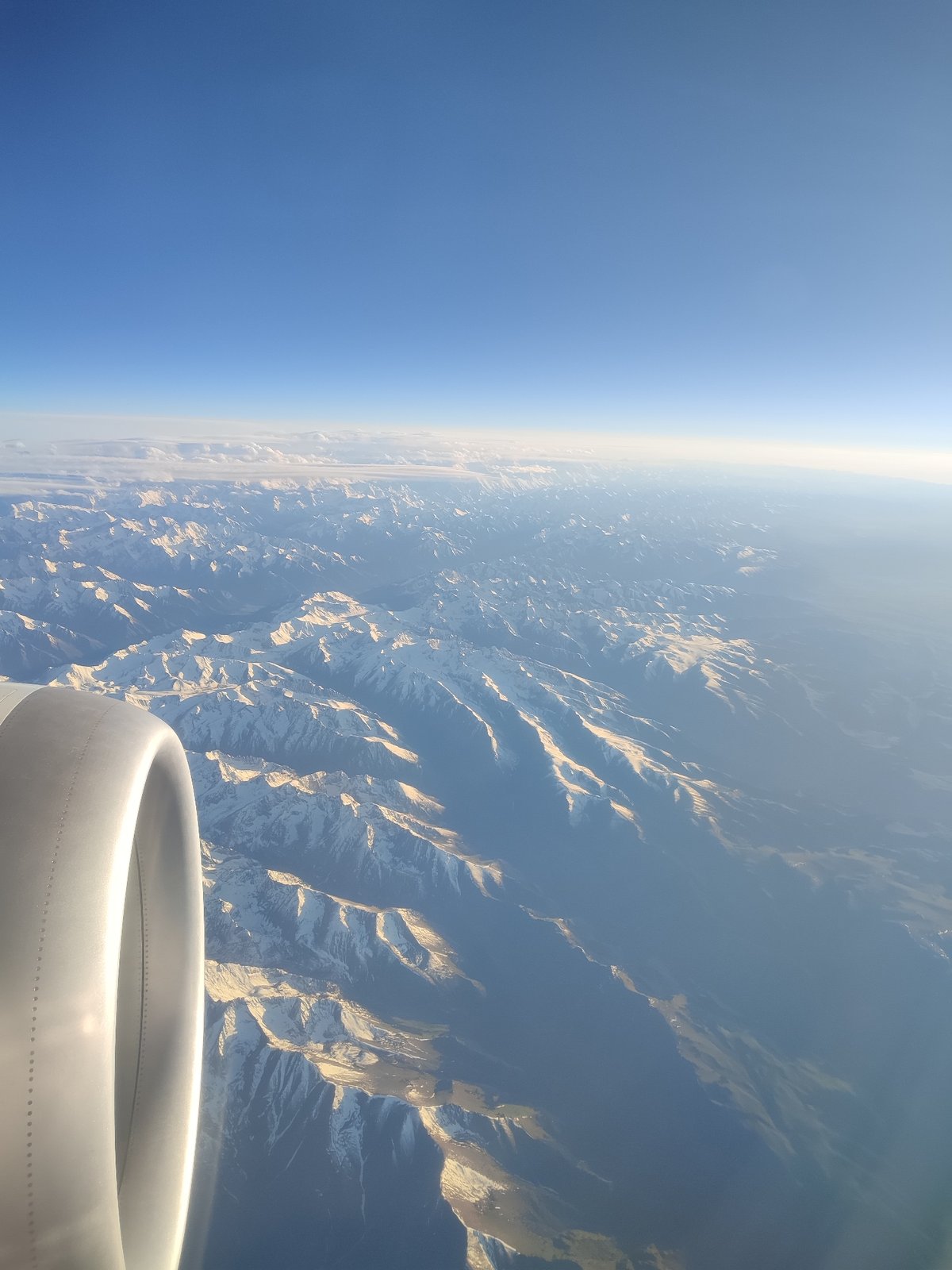 Aerial view captures snow-capped mountains from airplane over China