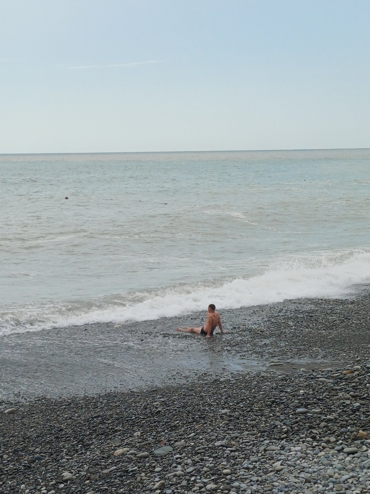 Quiet afternoon at the pebble beach on Sochi's coastline