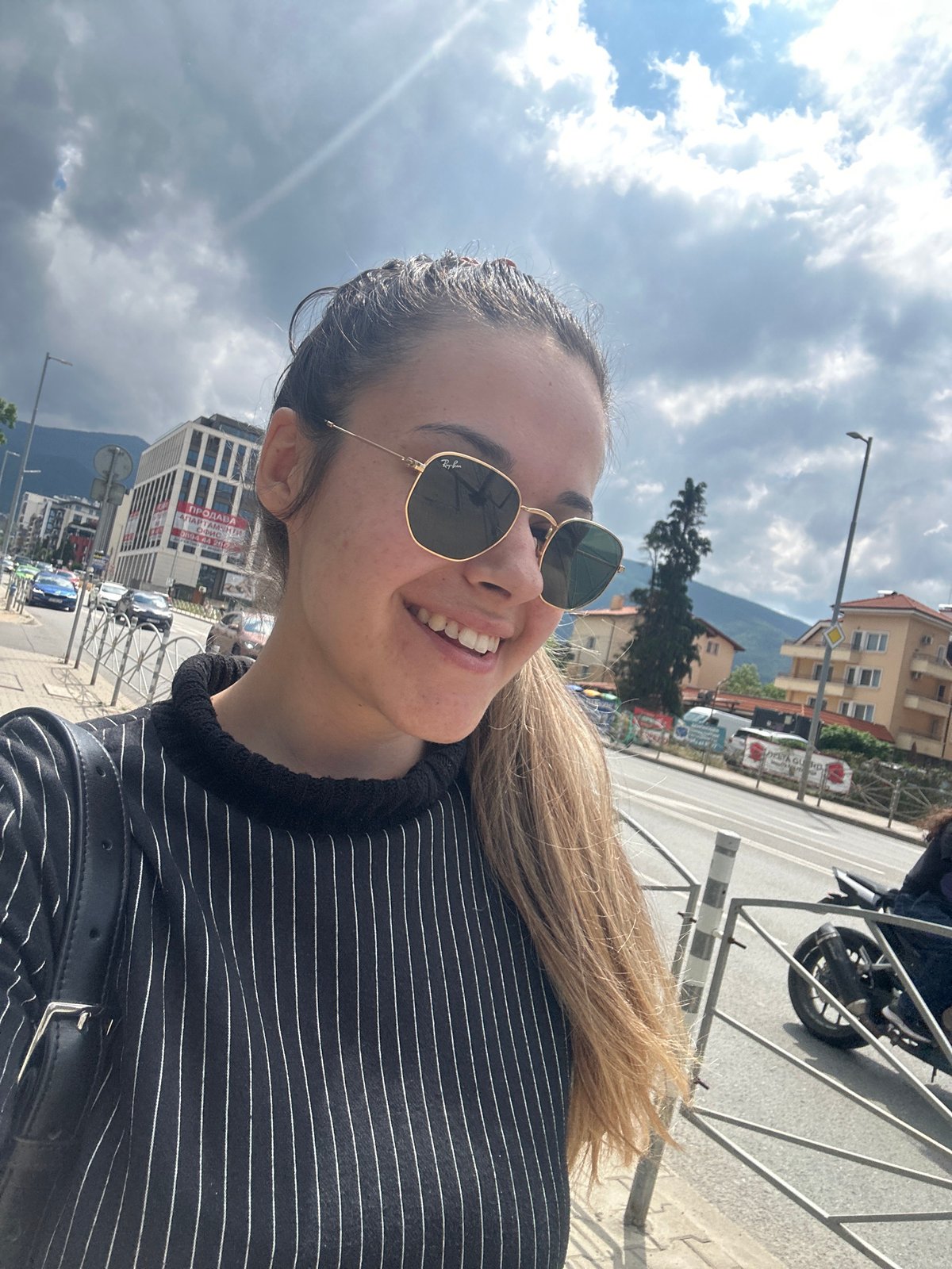 Woman takes creative selfies on sunny Sofia street