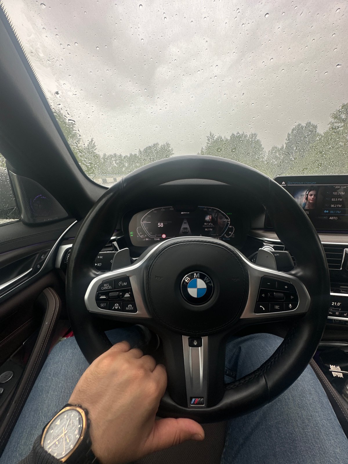 BMW driver navigates rainy roads at high speed